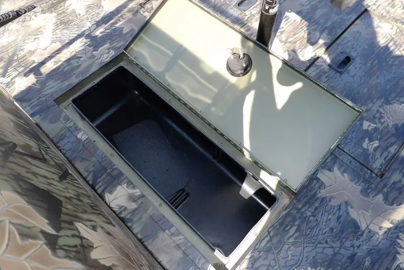 Slide: The Image of Open storage compartment on 2026 Crestliner 1760 Retriever FCC boat with camouflage design. - 37