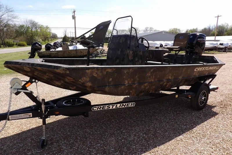 Slide: The Image of 2026 Crestliner 1760 Retriever FCC boat on trailer, camo design, parked outdoors. - 4
