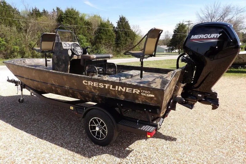 Slide: The Image of 2026 Crestliner 1760 Retriever FCC boat with Mercury engine, parked on gravel. - 7