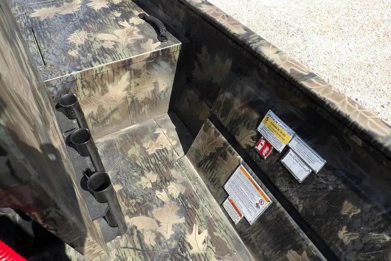 Slide: The Image of 2026 Crestliner 1760 Retriever FCC interior with camouflage design and safety labels. - 9