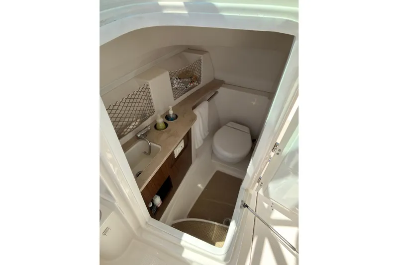 Slide: The Image of Control panel of a 2018 Sailfish 245 DC boat with radio and switches. - 13