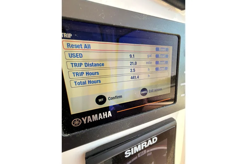 Slide: The Image of 2018 Sailfish 245 DC boat interior with seating, on a calm river. - 18