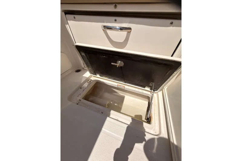 Slide: The Image of 2018 Sailfish 245 DC boat interior bathroom with sink, toilet, and storage. - 20