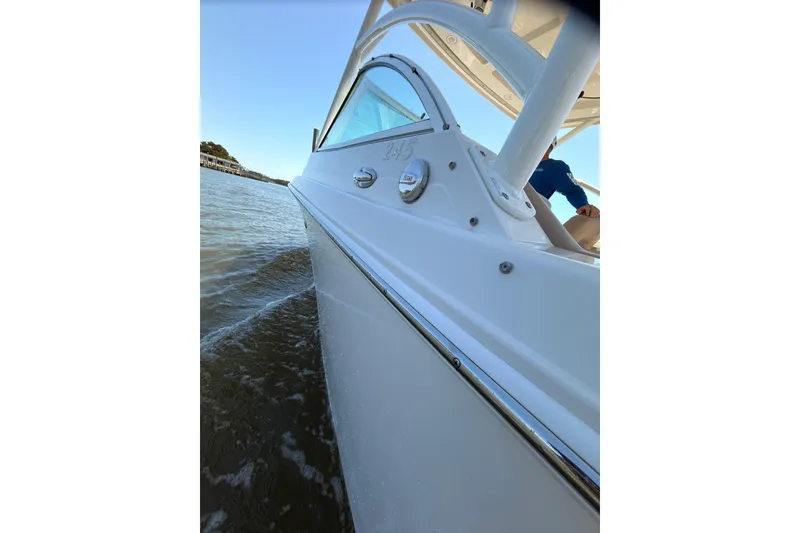 Slide: The Image of 2018 Sailfish 245 DC boat cruising on calm waters. - 24