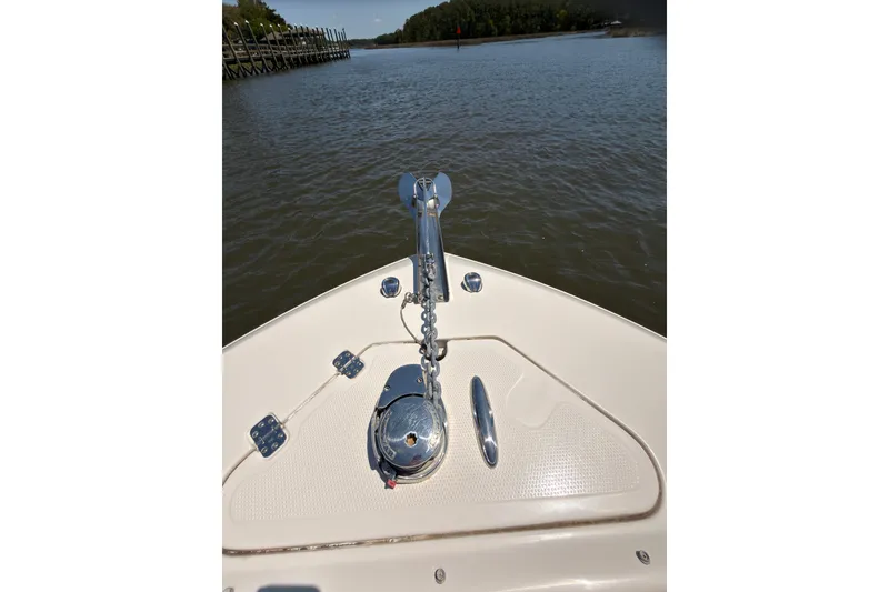 Slide: The Image of Bow view of 2018 Sailfish 245 DC boat with anchor chain and calm waters. - 27