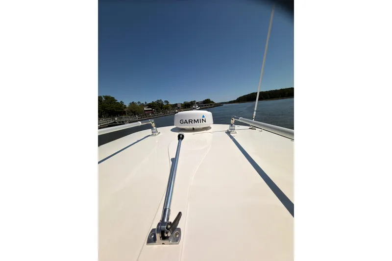 Slide: The Image of 2018 Sailfish 245 DC boat with Garmin equipment on calm water. - 30