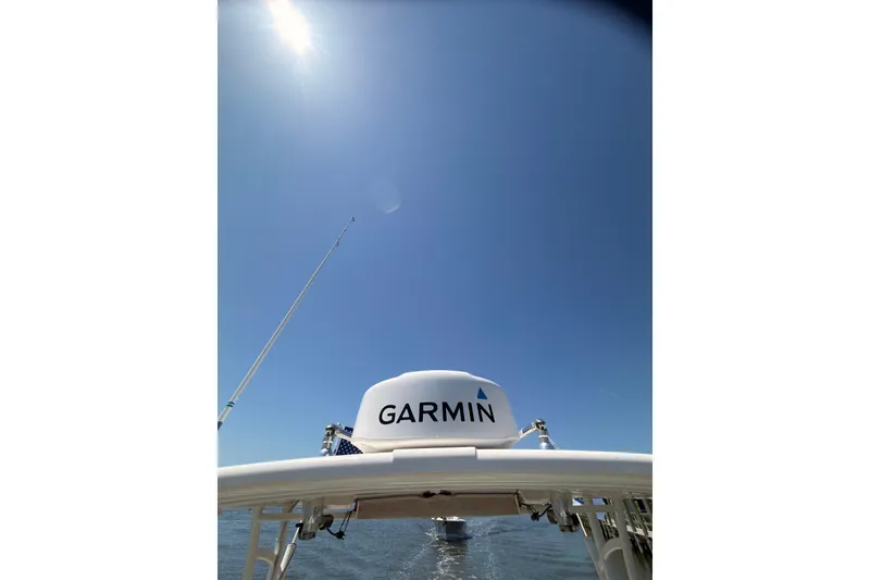 Slide: The Image of 2018 Sailfish 245 DC boat with Garmin equipment under clear blue sky. - 31