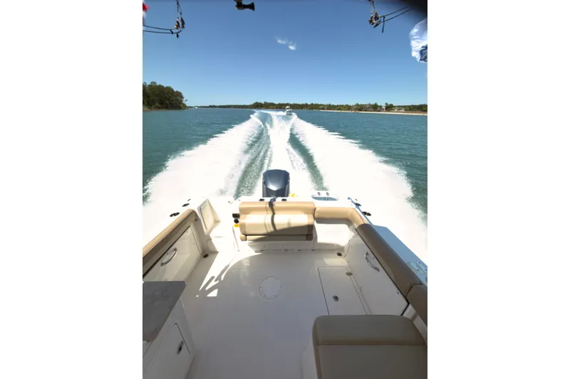 Slide: The Image of 2018 Sailfish 245 DC boat cruising on a sunny day, leaving a wake trail. - 7