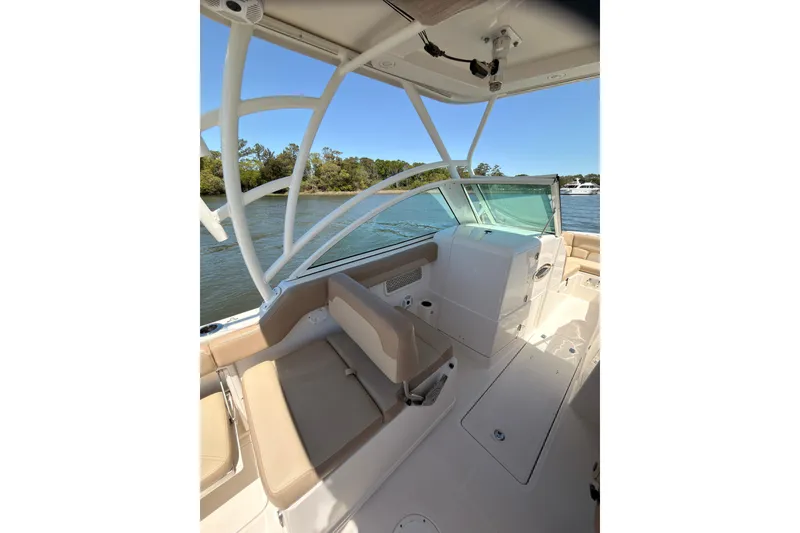 Slide: The Image of 2018 Sailfish 245 DC boat cruising on a sunny day. - 8