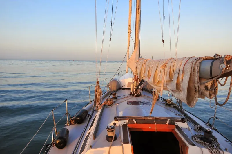 The Image of 1979 Islander Peterson 40 sailboat on calm sea at sunset. - 0