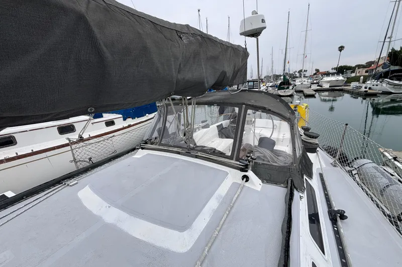 Slide: The Image of 1979 Islander Peterson 40 sailboat docked in a marina, featuring a covered cockpit and sleek design. - 20
