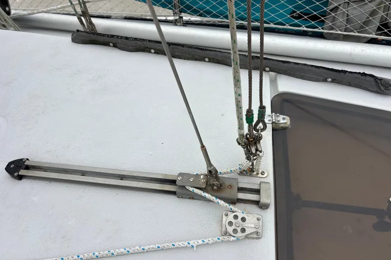 Slide: The Image of Deck rigging on 1979 Islander Peterson 40 sailboat, featuring ropes and pulleys. - 22