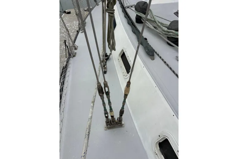 Slide: The Image of Deck rigging of a 1979 Islander Peterson 40 sailboat, showcasing ropes and fittings. - 23