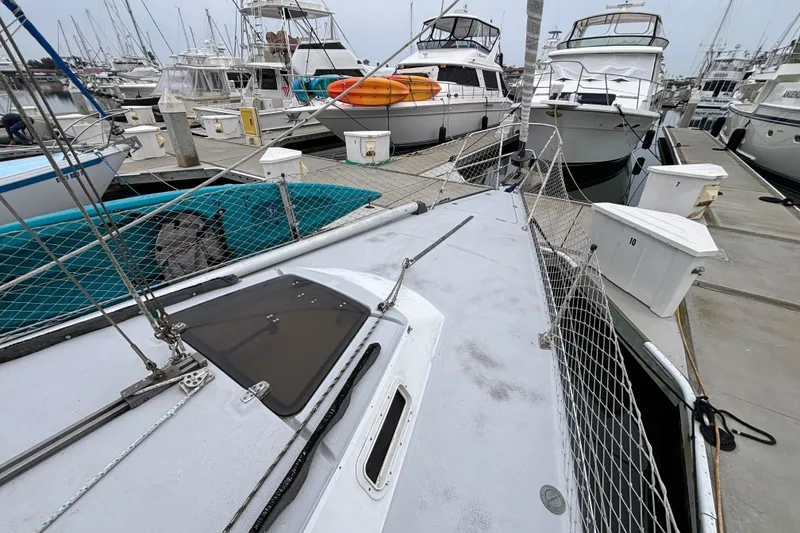 Slide: The Image of 1979 Islander Peterson 40 sailboat docked among other boats at a marina. - 32