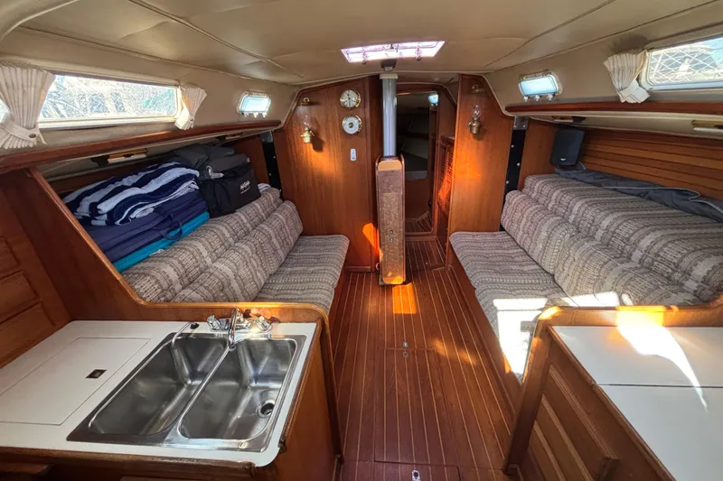 Slide: The Image of Interior of 1979 Islander Peterson 40 sailboat with wood paneling and cozy seating. - 37