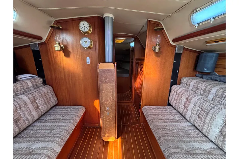 Slide: The Image of Interior of 1979 Islander Peterson 40 sailboat with wood paneling and cozy seating. - 38