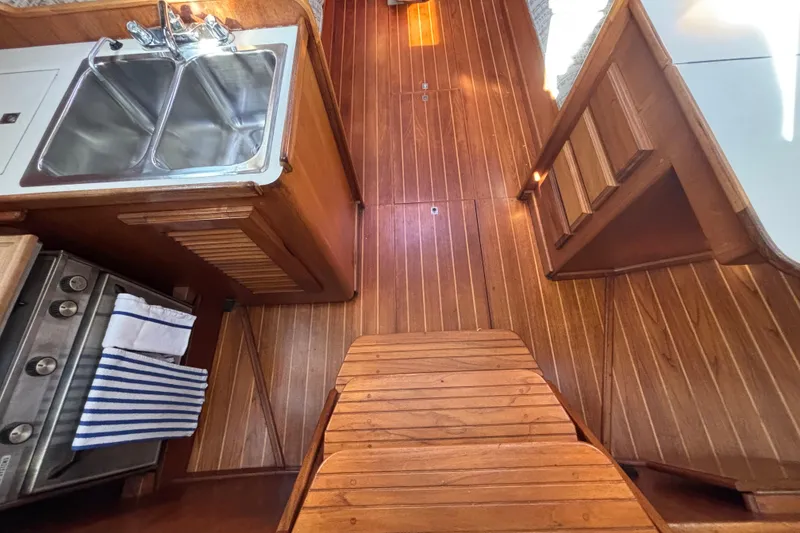 Slide: The Image of Wooden interior of 1979 Islander Peterson 40 sailboat with sink and stove. - 41