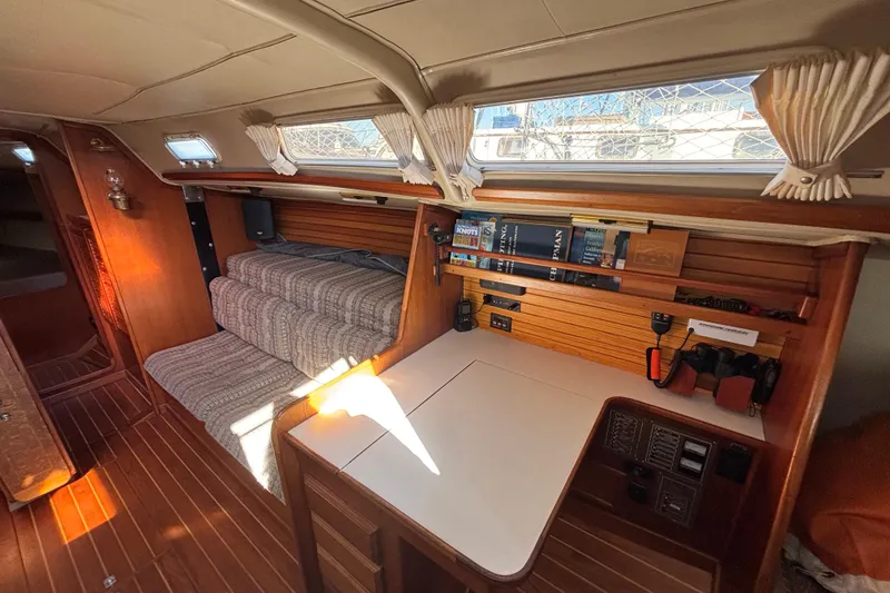 Slide: The Image of Interior of 1979 Islander Peterson 40 sailboat with cozy seating and navigation station. - 42