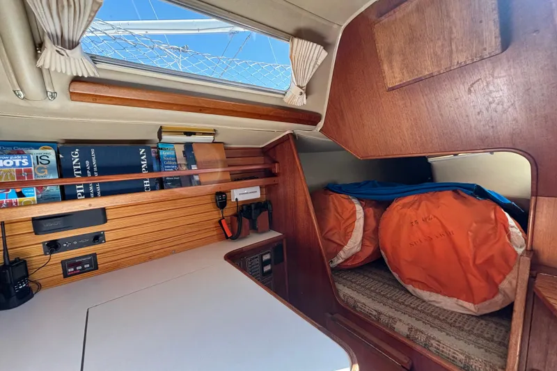 Slide: The Image of Interior of 1979 Islander Peterson 40 sailboat with books, electronics, and storage area. - 44