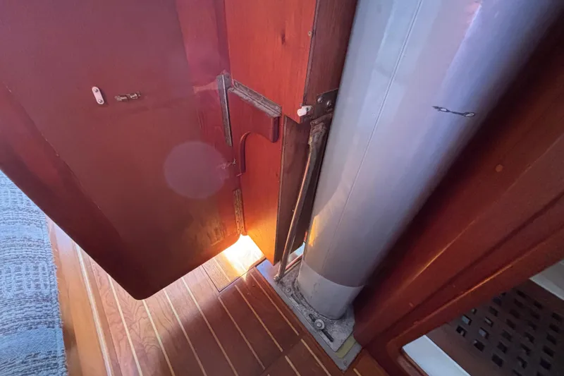 Slide: The Image of Interior view of 1979 Islander Peterson 40 sailboat, featuring wooden flooring and mast detail. - 50