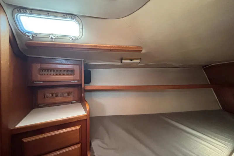 Slide: The Image of Interior cabin of 1979 Islander Peterson 40 sailboat with wooden storage and bed. - 56