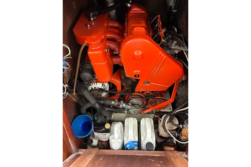 Slide: The Image of Engine compartment of a 1979 Islander Peterson 40 sailboat with bright orange components. - 57