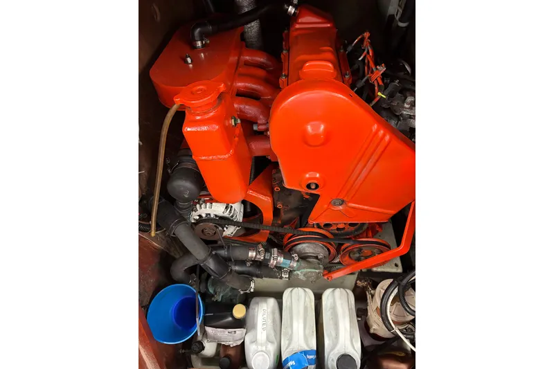 Slide: The Image of Engine compartment of a 1979 Islander Peterson 40 sailboat, featuring a bright red engine. - 58