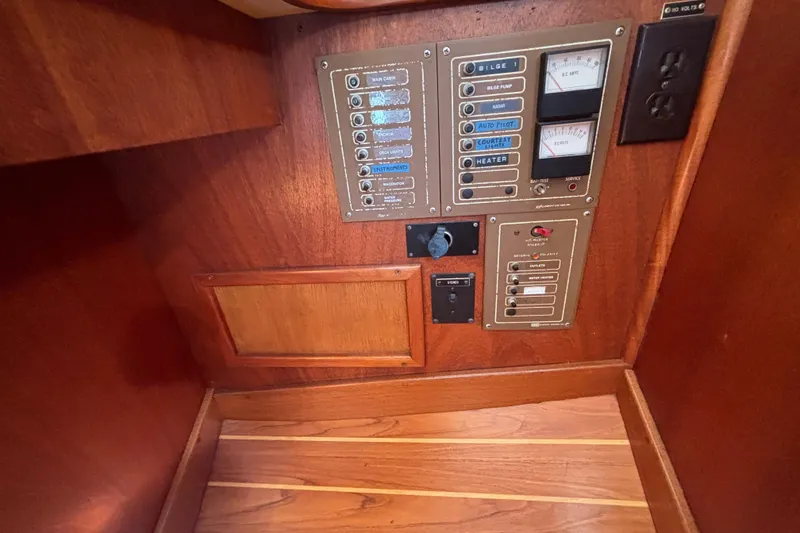 Slide: The Image of Electrical control panel on 1979 Islander Peterson 40 sailboat, featuring switches and gauges. - 59