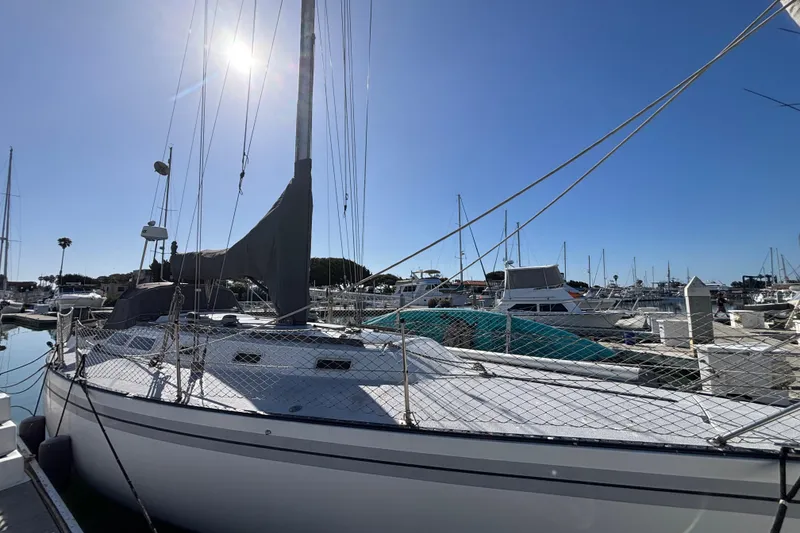 Slide: The Image of 1979 Islander Peterson 40 sailboat docked in a sunny marina. - 6