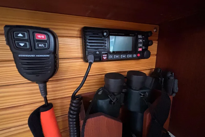 Slide: The Image of Radio and binoculars on 1979 Islander Peterson 40 yacht's wooden interior. - 61