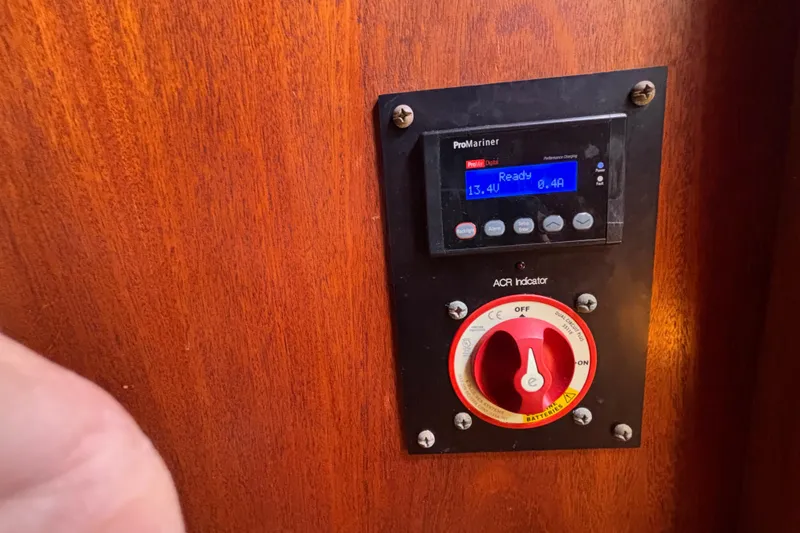 Slide: The Image of Control panel on 1979 Islander Peterson 40 sailboat, featuring ProMariner display and ACR indicator. - 62