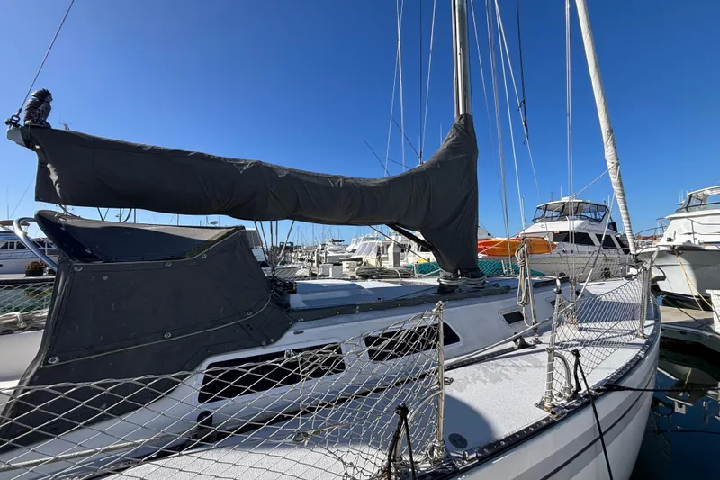 Slide: The Image of 1979 Islander Peterson 40 sailboat docked at marina under clear blue sky. - 8
