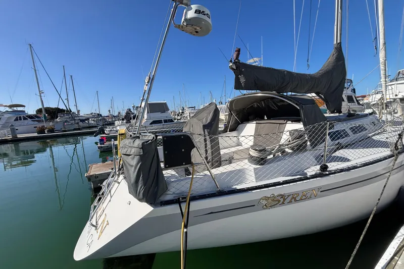 Slide: The Image of 1979 Islander Peterson 40 sailboat docked in a marina under clear blue skies. - 9
