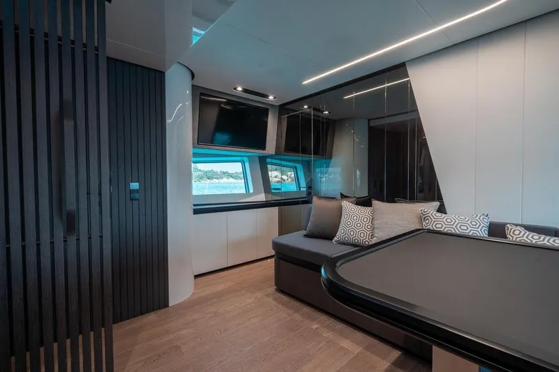 Slide: The Image of Modern yacht interior with sleek design, featuring a cozy seating area and large windows. - 4