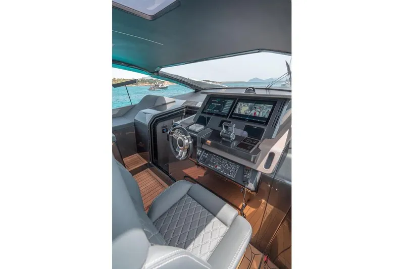 Slide: The Image of Luxury yacht cockpit with modern controls, Maori Family 2022 model, featuring dual screens and leather seating. - 7