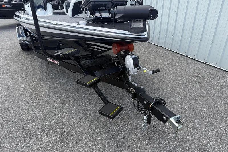 Slide: The Image of 2023 Phoenix 921 Elite II boat trailer with steps and winch, parked on asphalt. - 14