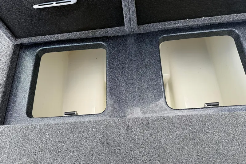 Slide: The Image of Storage compartments in a 2023 Phoenix 921 Elite II boat, featuring a sleek, carpeted finish. - 17