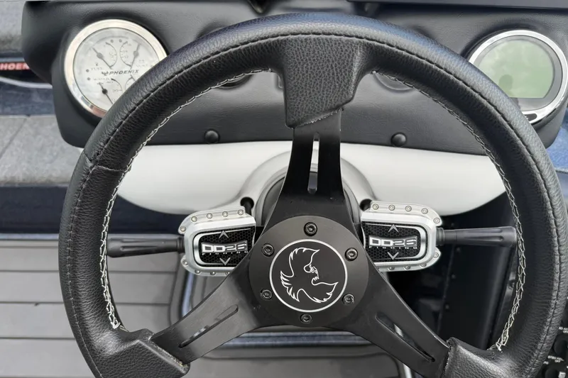 Slide: The Image of Steering wheel of 2023 Phoenix 921 Elite II boat with dashboard gauges. - 22