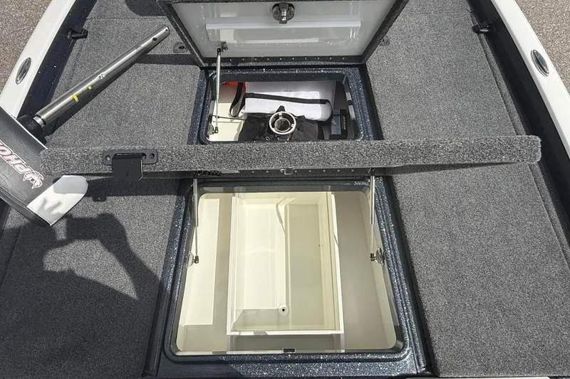 Slide: The Image of 2023 Phoenix 921 Elite II boat storage compartments with carpeted interior and equipment. - 34