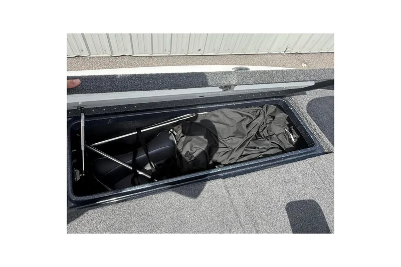 Slide: The Image of Open storage compartment in 2023 Phoenix 921 Elite II boat, showing interior contents. - 36