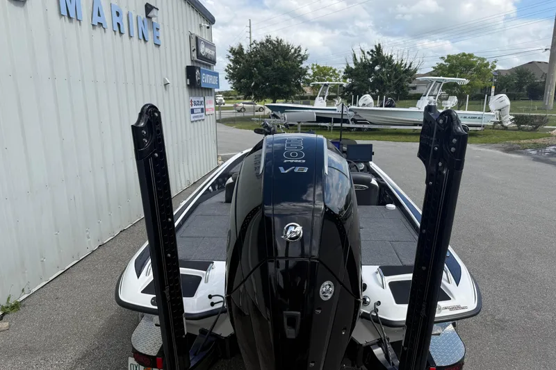 Slide: The Image of 2023 Phoenix 921 Elite II boat with V8 engine at a marine dealership. - 6
