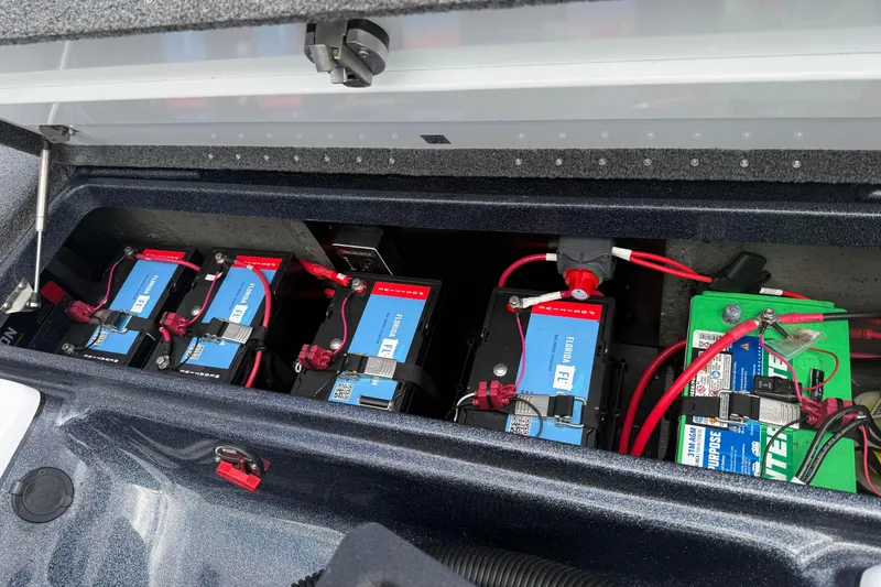 Slide: The Image of 2023 Phoenix 921 Elite II boat battery compartment with multiple batteries and wiring. - 8