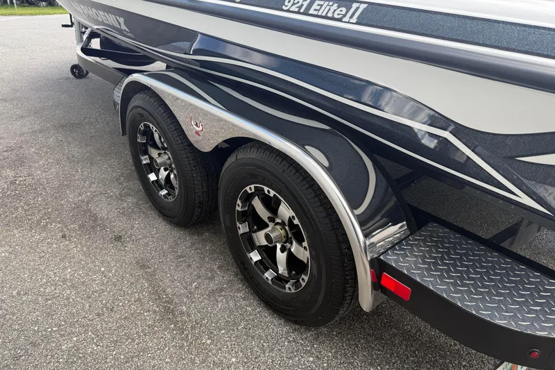 Slide: The Image of 2023 Phoenix 921 Elite II boat trailer with dual wheels on asphalt. - 9