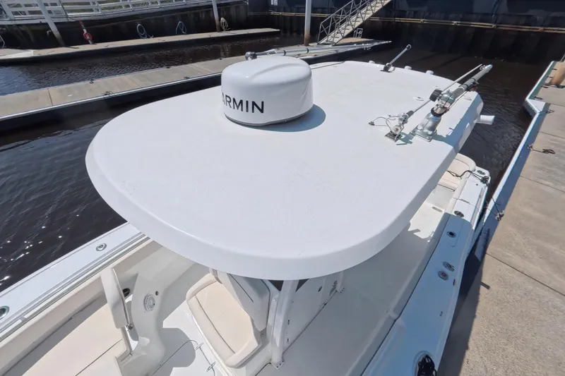 Slide: The Image of 2025 Sea Hunt Ultra 275 SE boat docked at marina. - 8