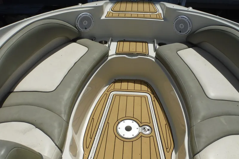 Slide: The Image of 2005 Sea Ray 220 Sundeck interior with cushioned seating and teak-style flooring. - 10