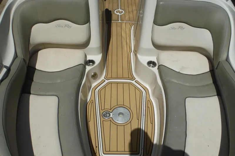 Slide: The Image of Interior seating of a 2005 Sea Ray 220 Sundeck boat with teak flooring. - 11