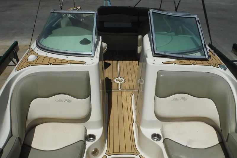 Slide: The Image of 2005 Sea Ray 220 Sundeck boat interior with seating and open windshield. - 12