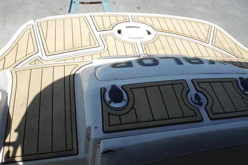 Slide: The Image of Rear deck of a 2005 Sea Ray 220 Sundeck with tan marine flooring. - 25