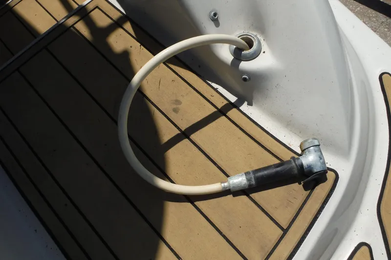 Slide: The Image of Deck of 2005 Sea Ray 220 Sundeck with hose attachment. - 27