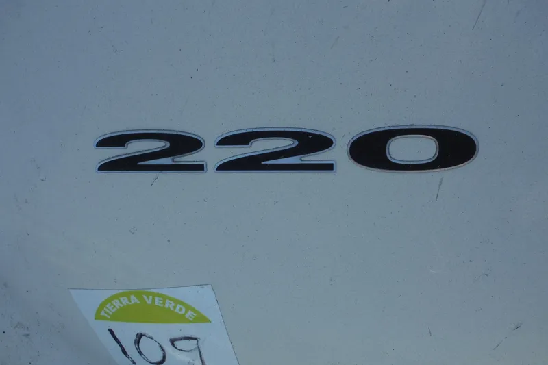 Slide: The Image of Close-up of 2005 Sea Ray 220 Sundeck model number on boat hull. - 28
